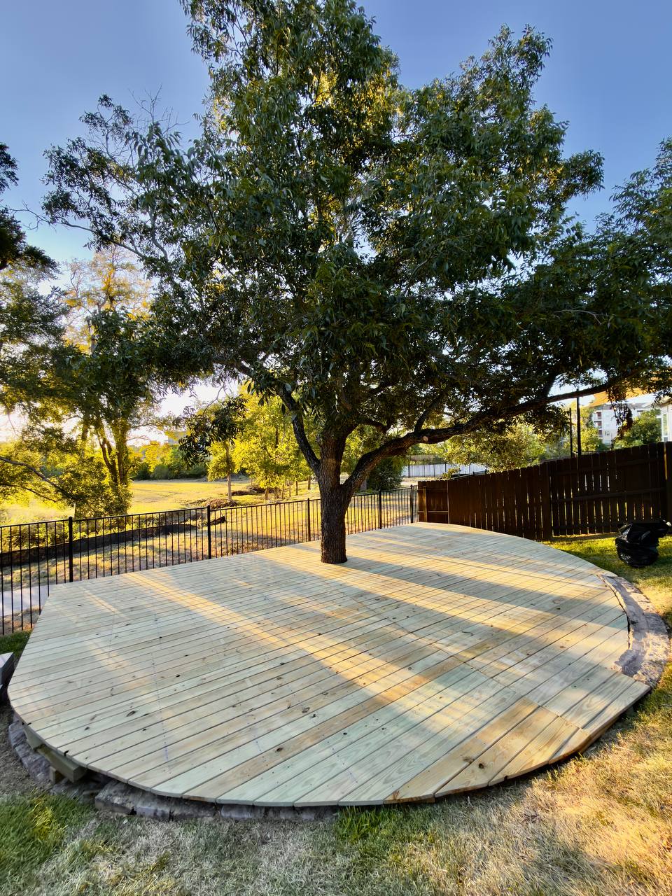 Custom round wood deck built around a tree Cedar Park TX