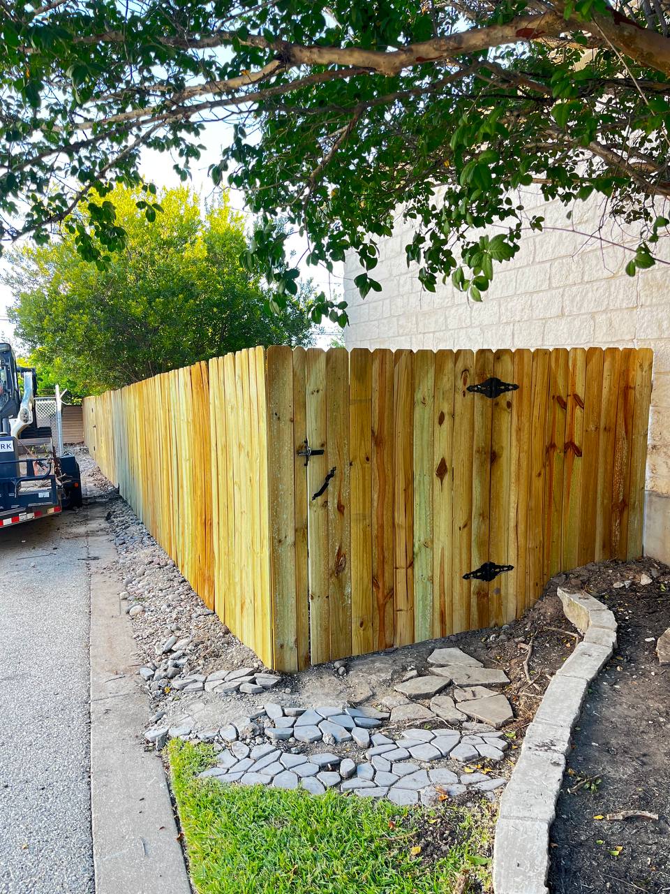 Pressure-treated pine privacy fence and gate on corner lot Cedar Park TX