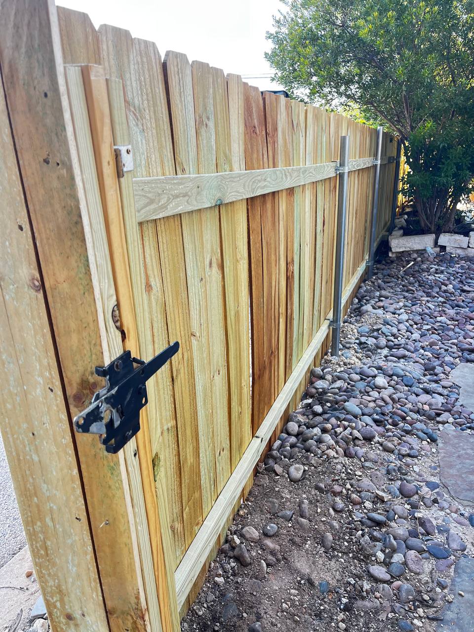 Wood gate frame with latch on galvanized metal posts Cedar Park TX