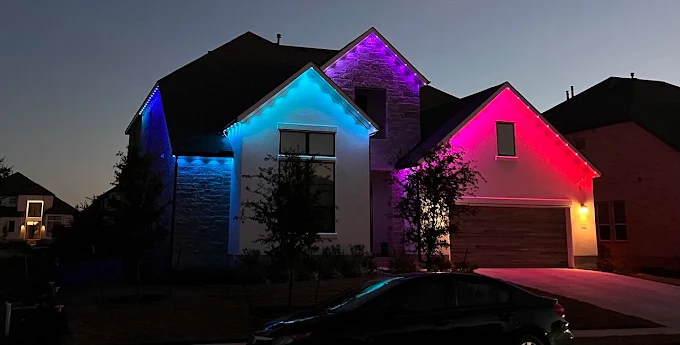 Govee permanent outdoor lights multi-color scene at dusk on a stone and stucco home Cedar Park TX
