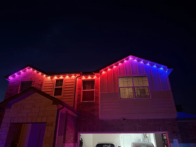 Govee permanent outdoor lights red and blue scene on a two-story brick home near Austin TX